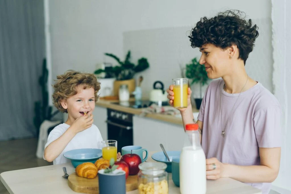 Parent eating breakfast with their child