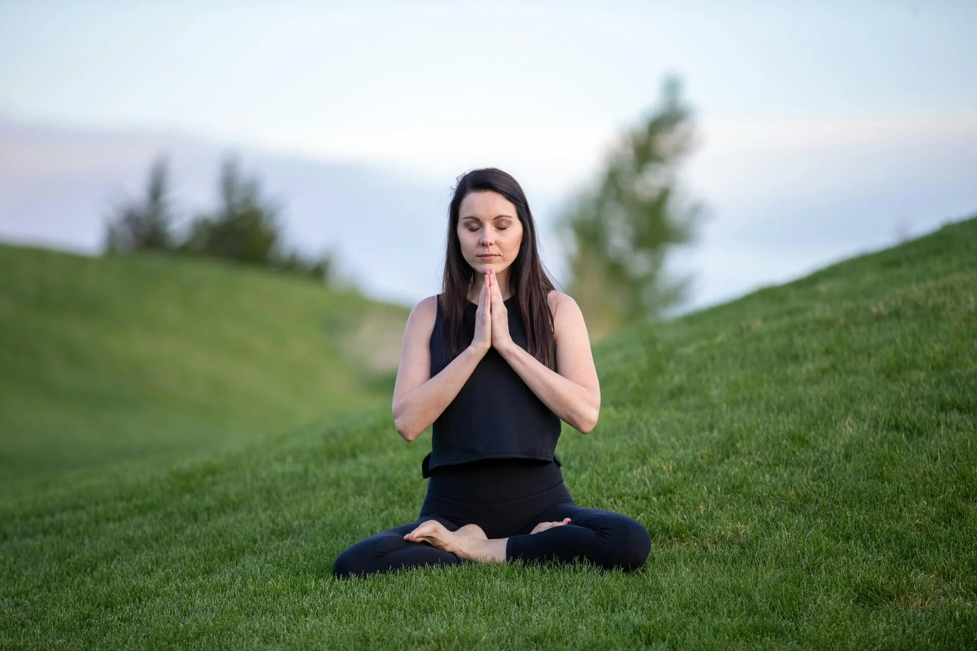 A woman meditating with her hands under her chin