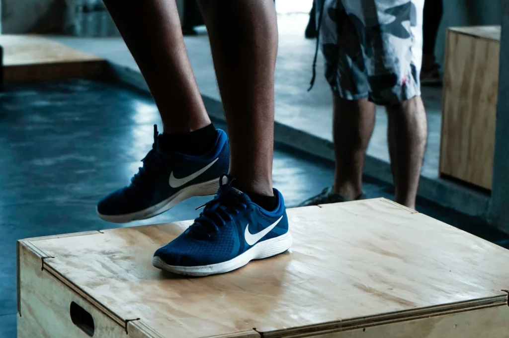 Person with Nike shoes standing on a box