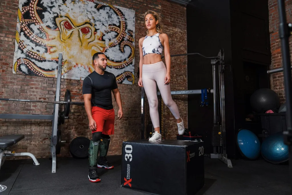 Woman standing on top of a box at the gym