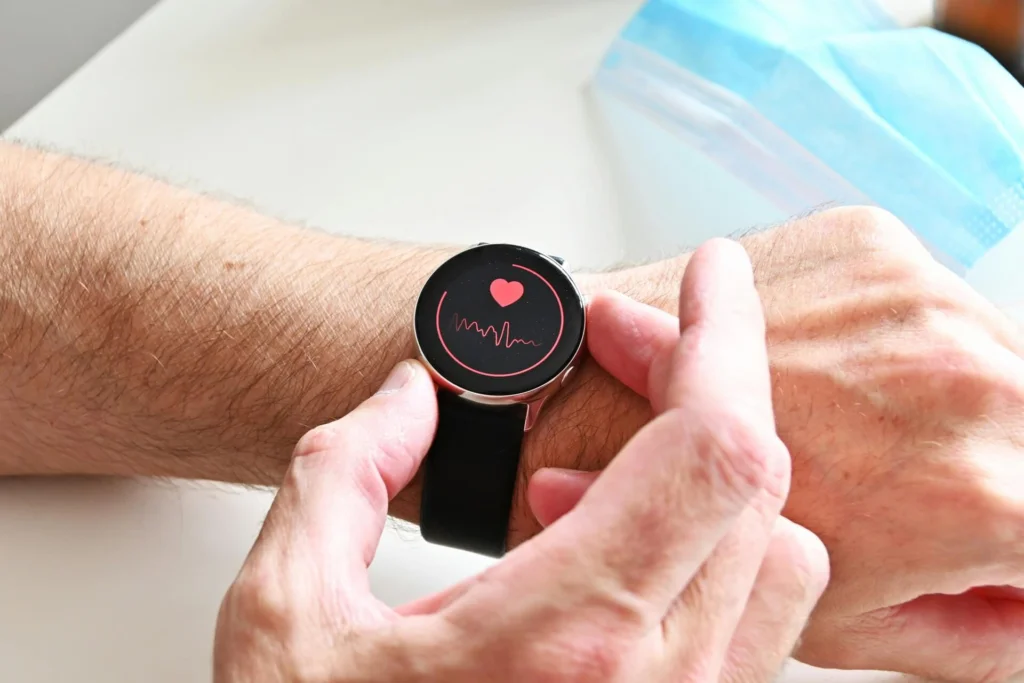 A person checking their heart rate on a smart watch