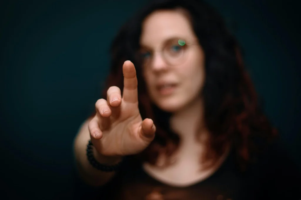 A woman with her finger extended toward the camera