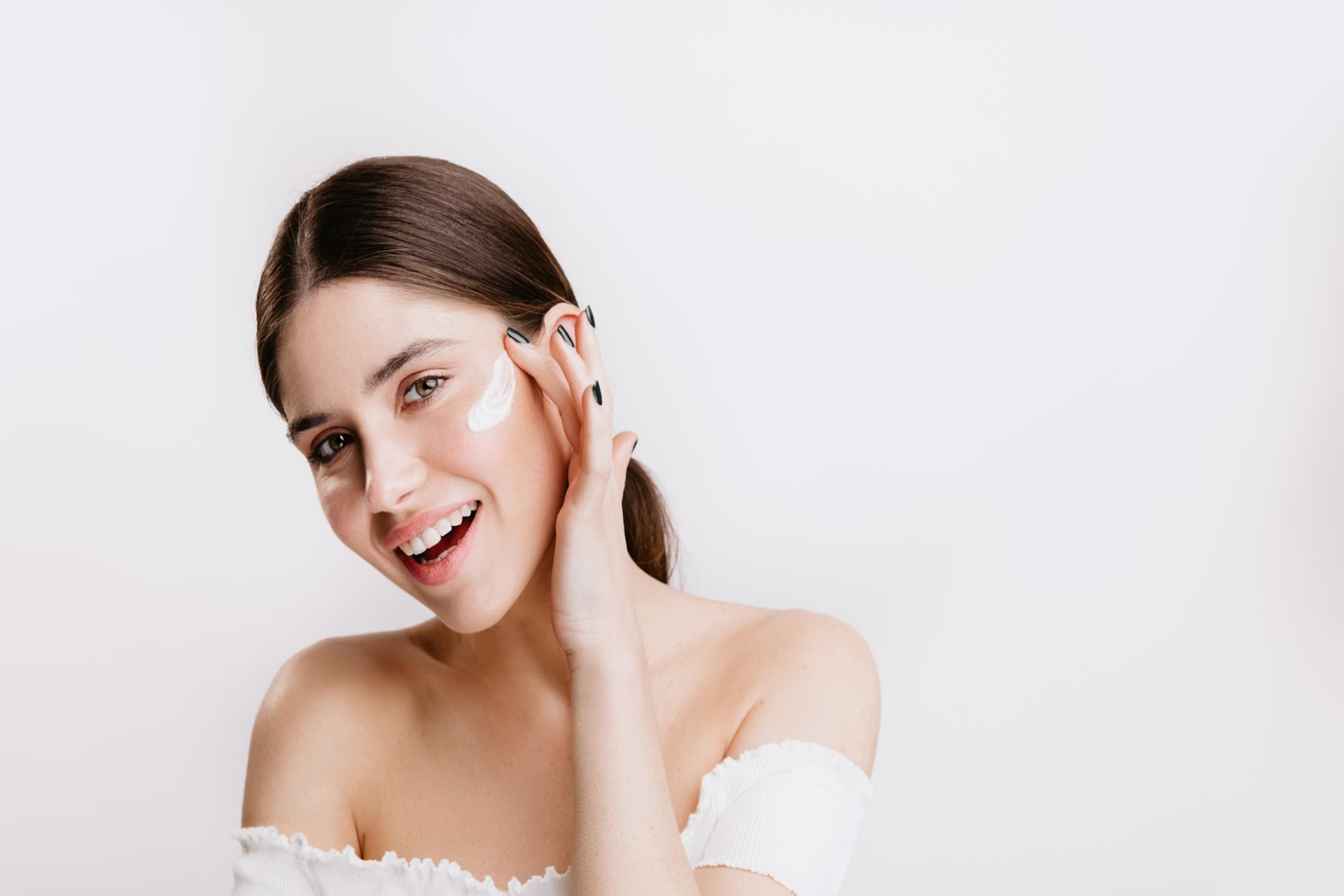 woman applying skin care product