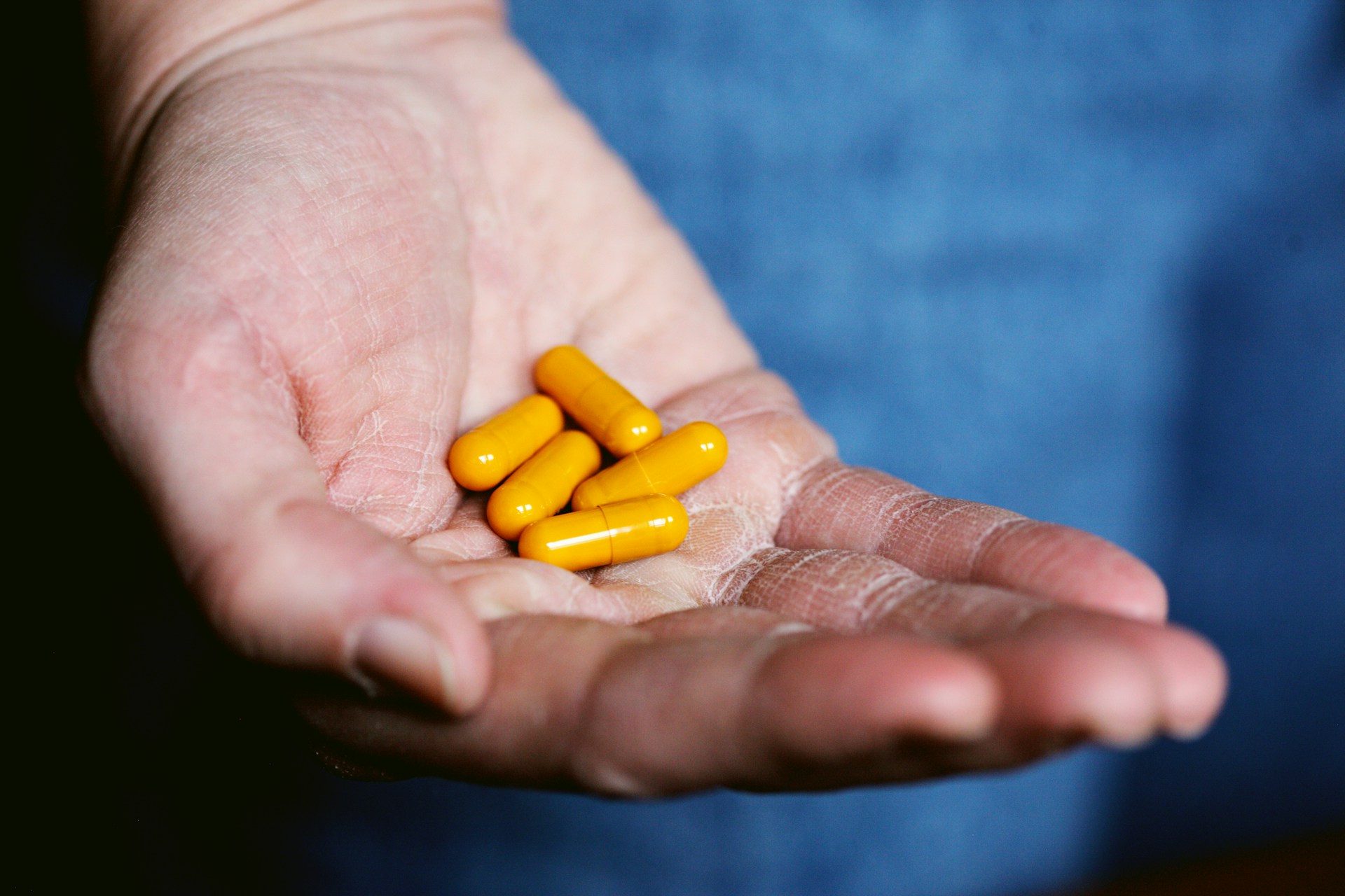 berberine yellow pills on a person's hand