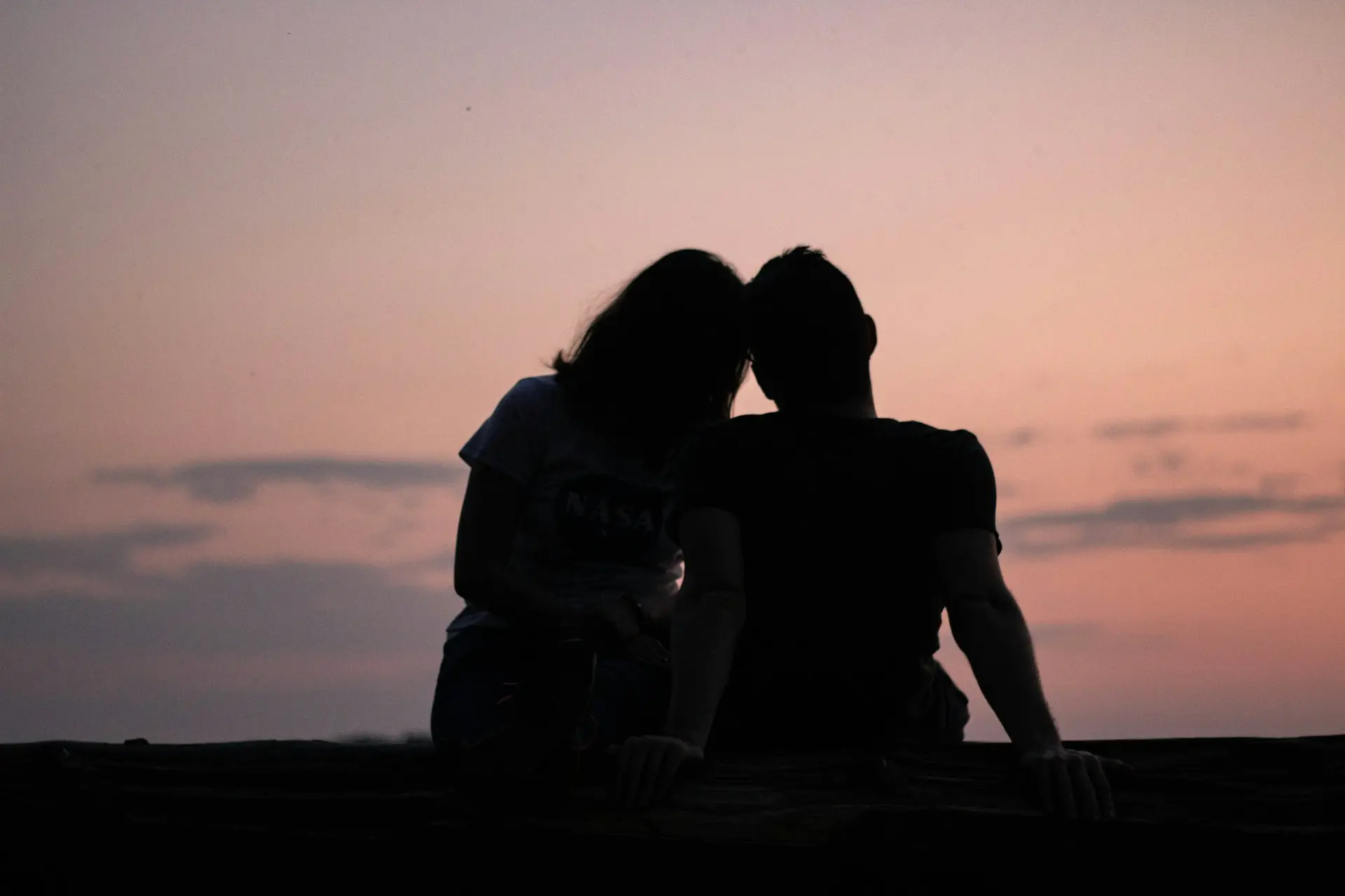 man and woman silhouettes in front of the sky