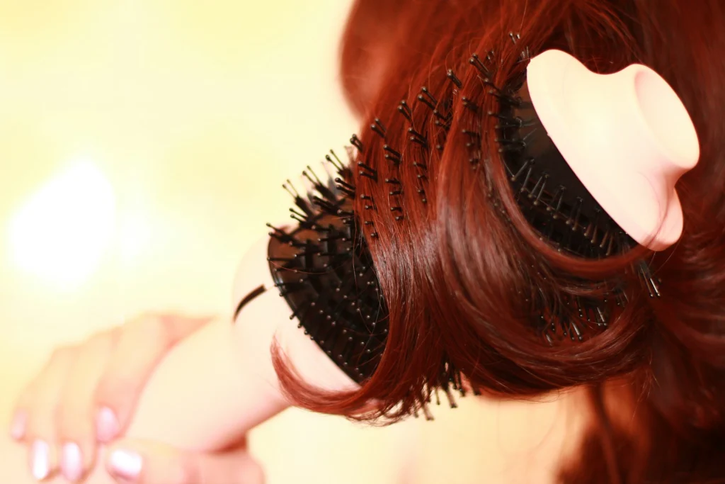 woman brushing red hair