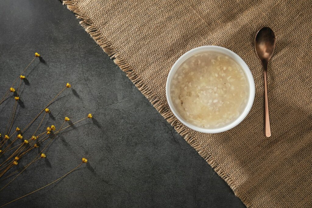 A bowl of barley porridge on a brown linen cloth
