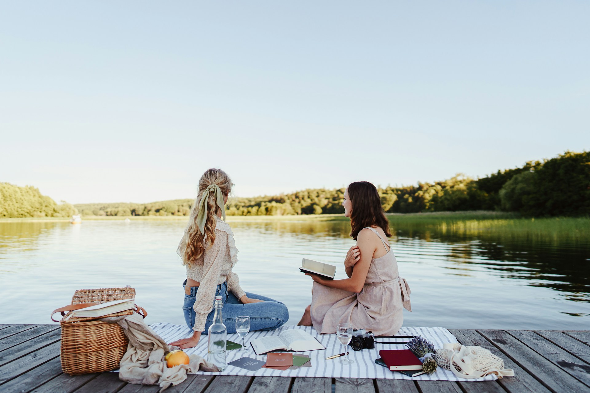 Two woman on a picnic by the lake as a fun summer date idea