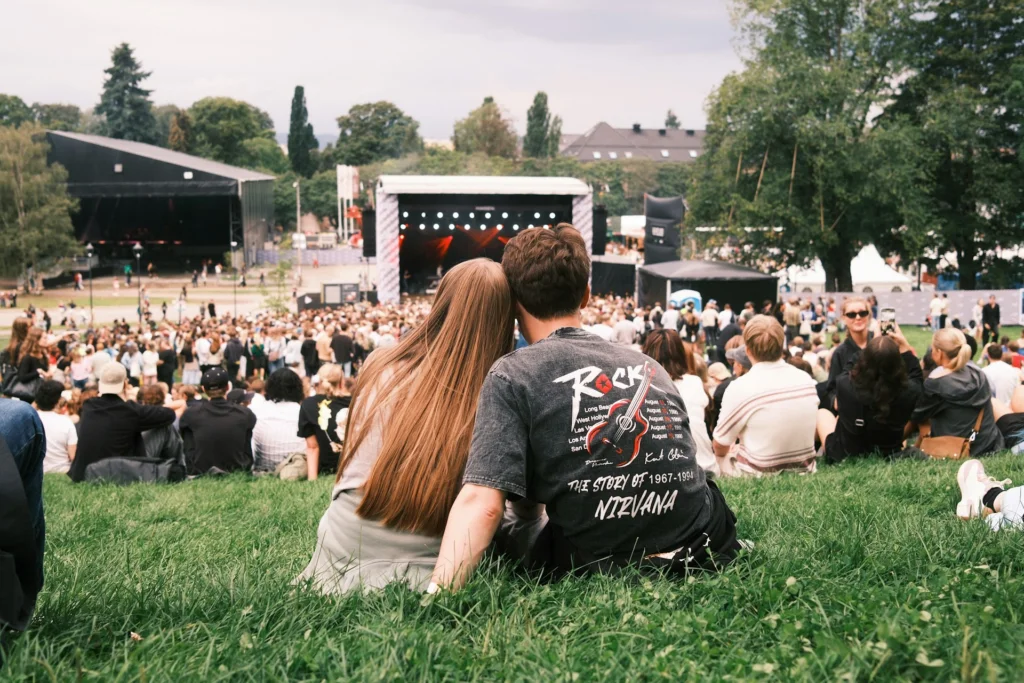 A woman and man enjoying an outdoor concert as a fun summer date ideas