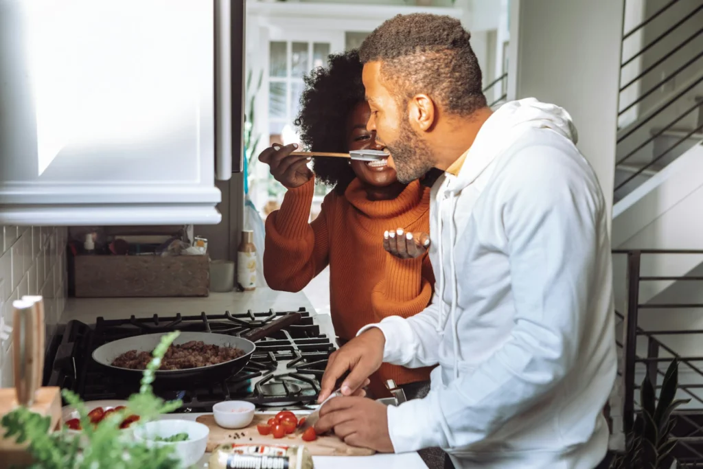 A couple cooking together as a fun summer date idea