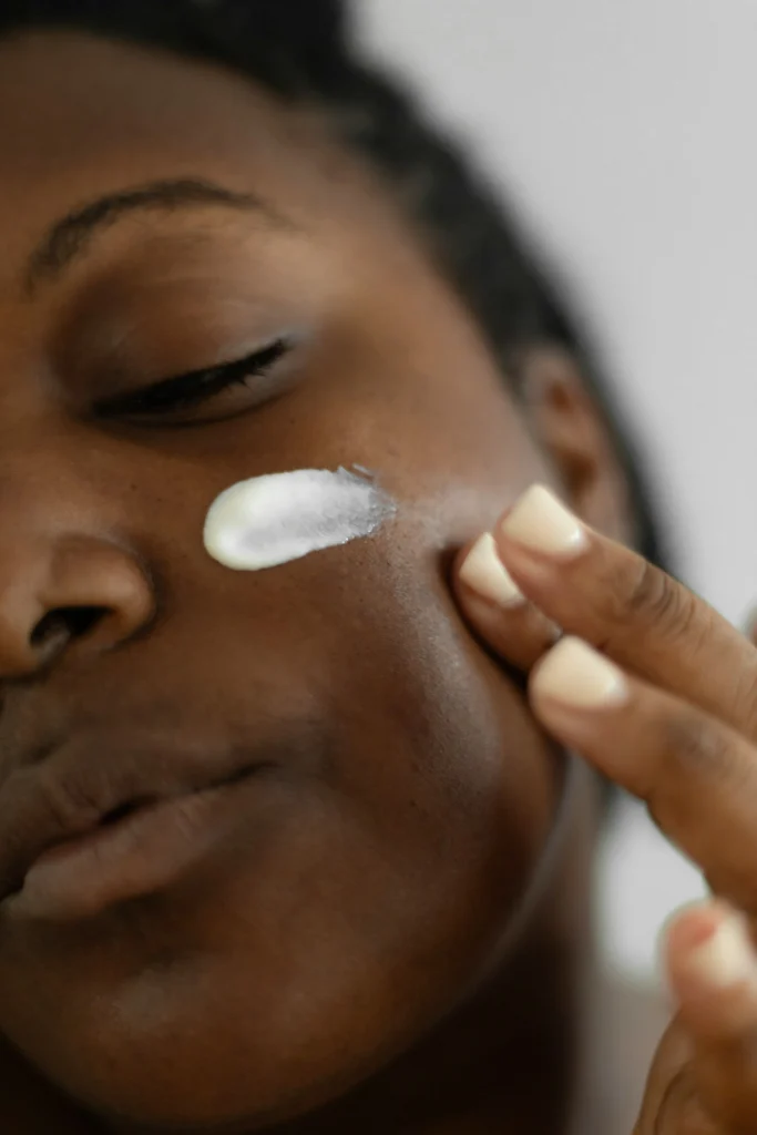 A girl applying face cream