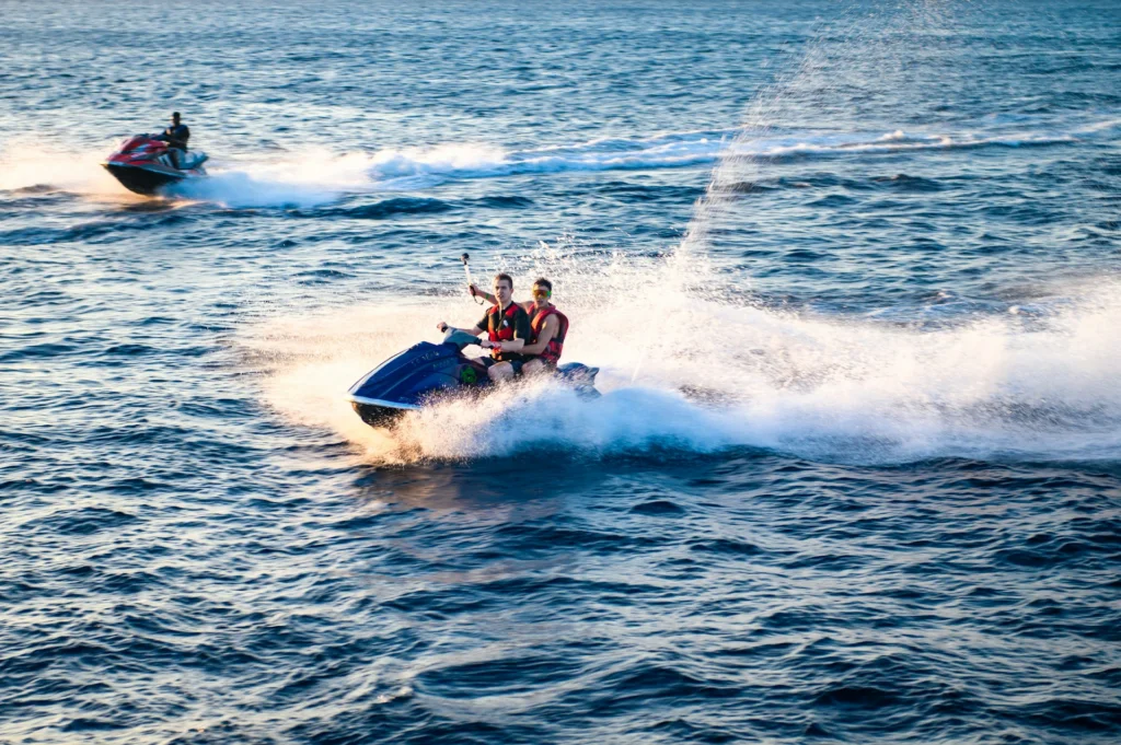 Two men jet skiing on the ocean fir fun summer date ideas