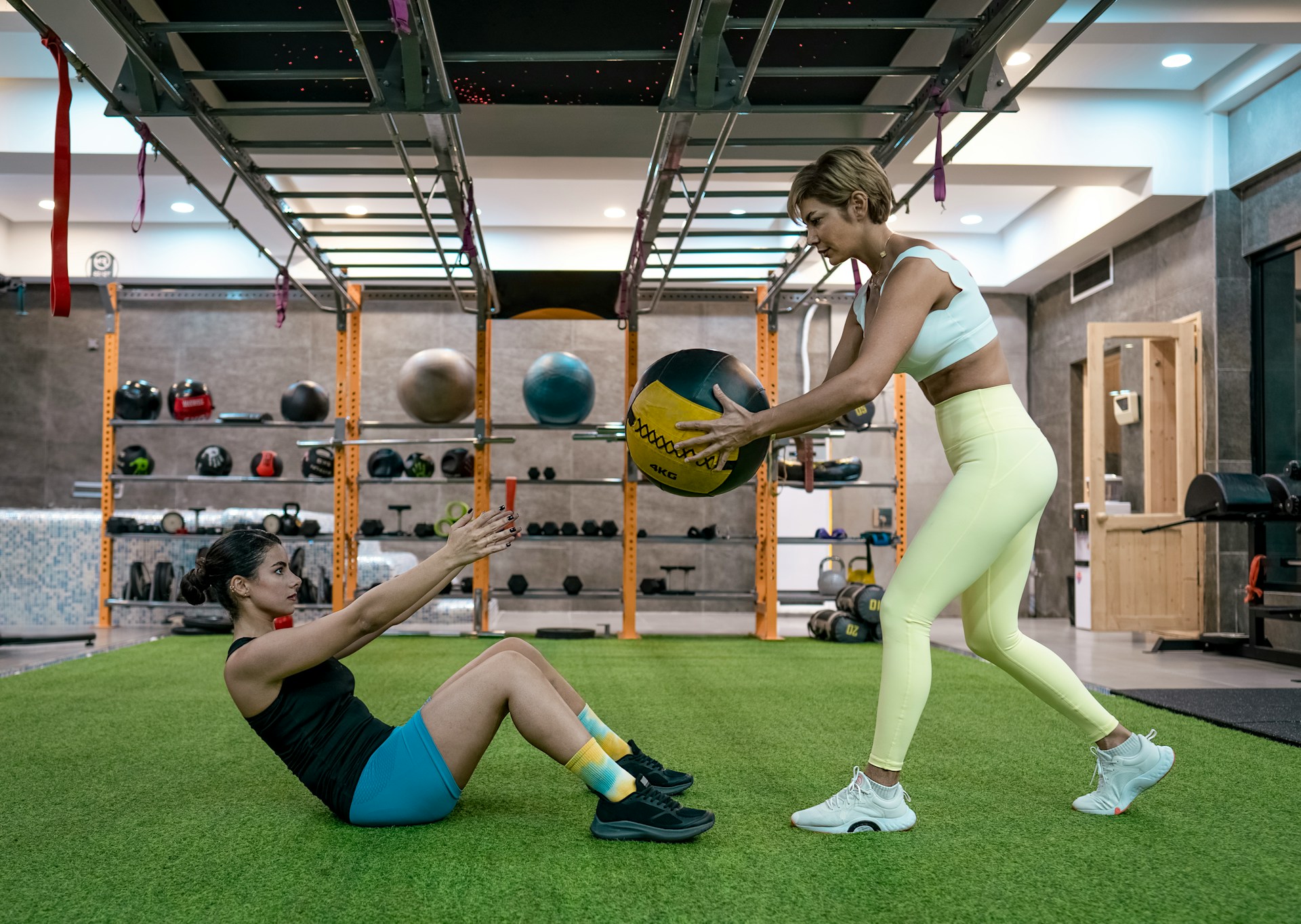 Two women doing weighted ab exercises