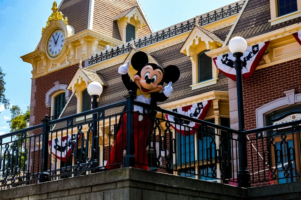 Mickey Mouse waving to the camere in a Disneyland