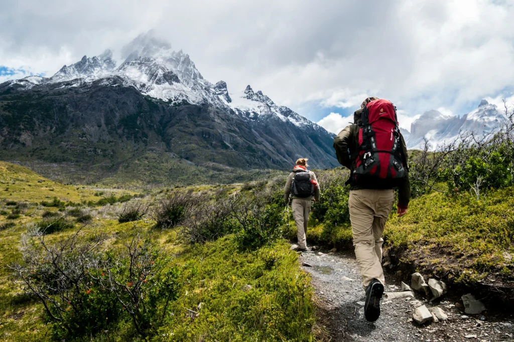 Two people hiking with the mountain in the backdrop