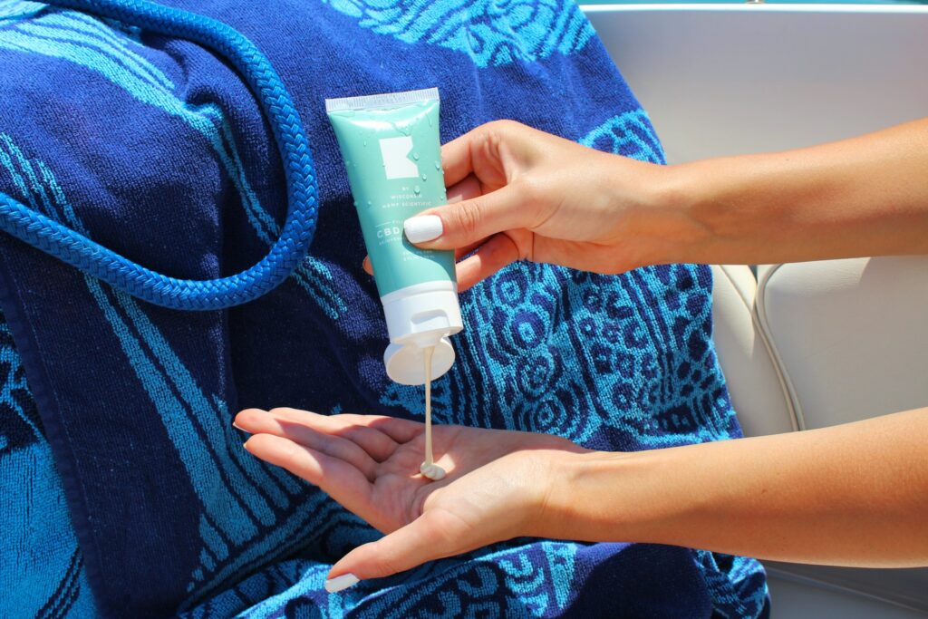 woman putting sunscreen on hand