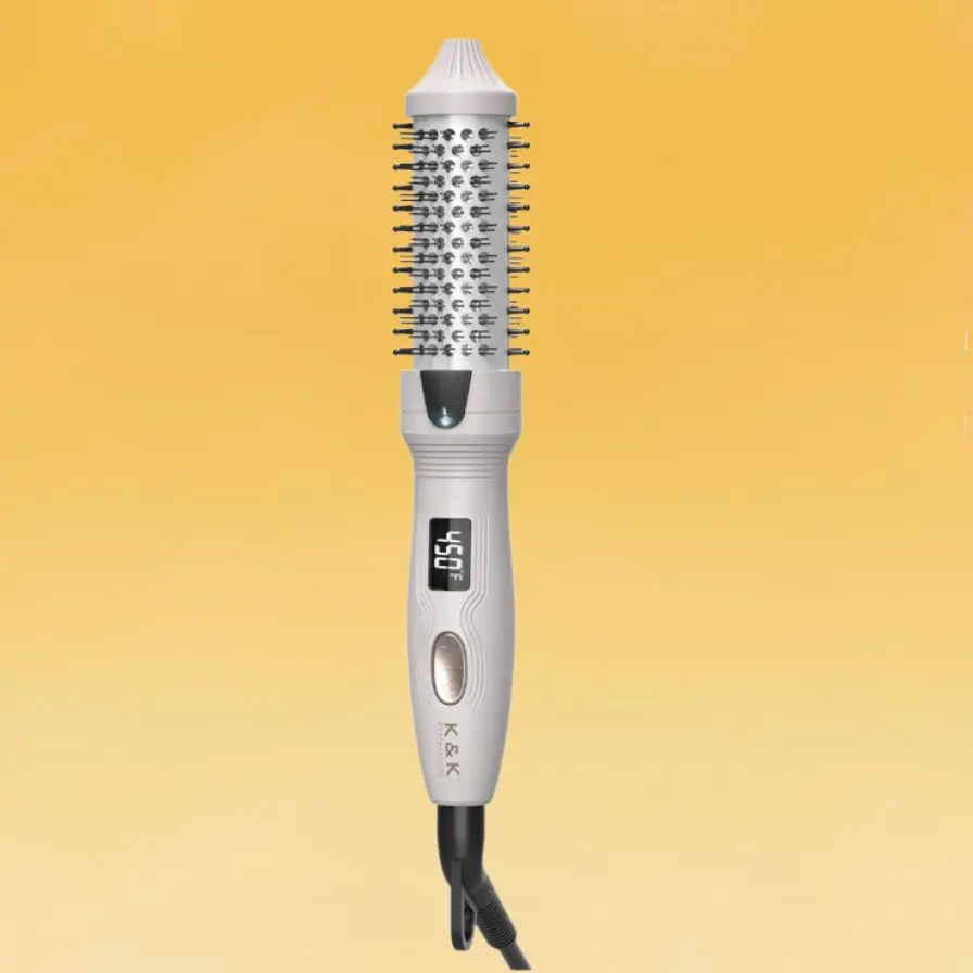 A white K&K Mini Thermal Brush digital display showing 450° Fahrenheit. It has a cylindrical barrel with bristles.