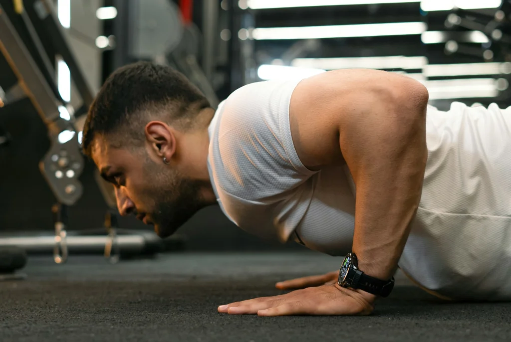 A man in a white shirt doing push-ups