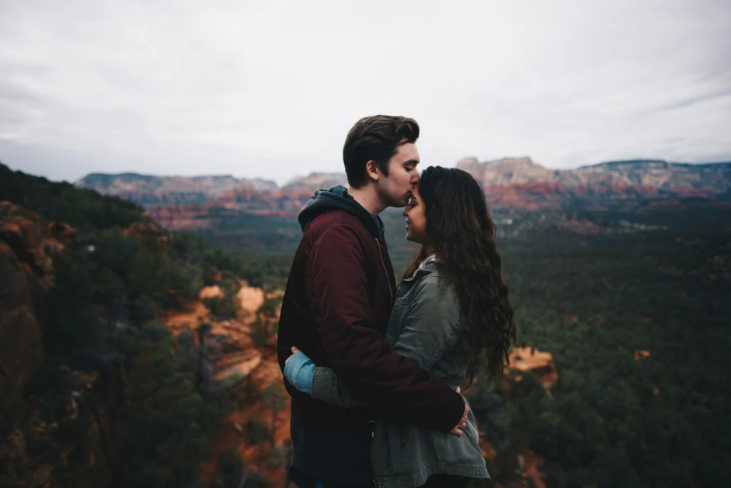 A couple embracing in the mountains.