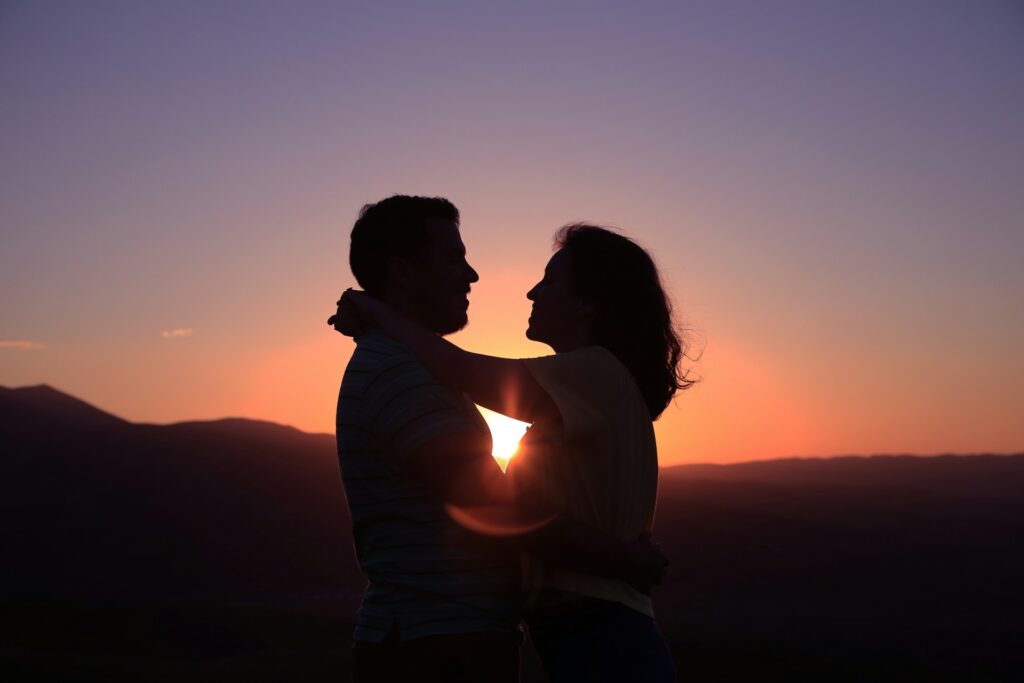 A couple hugging at sunset.