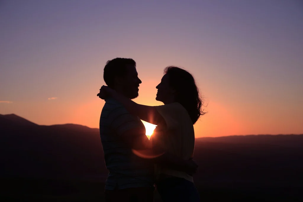 A couple hugging at sunset.