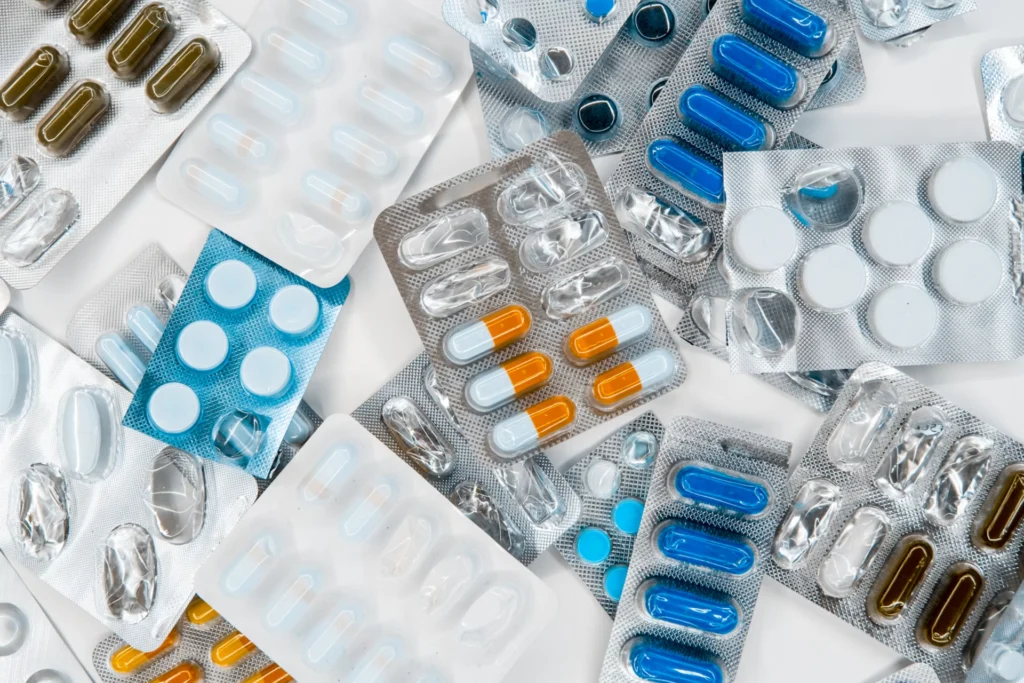 different colored capsules and tablets in wrappers