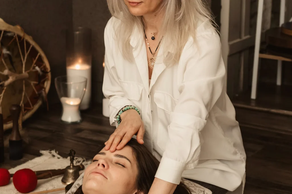 woman in white touching another woman on forehead