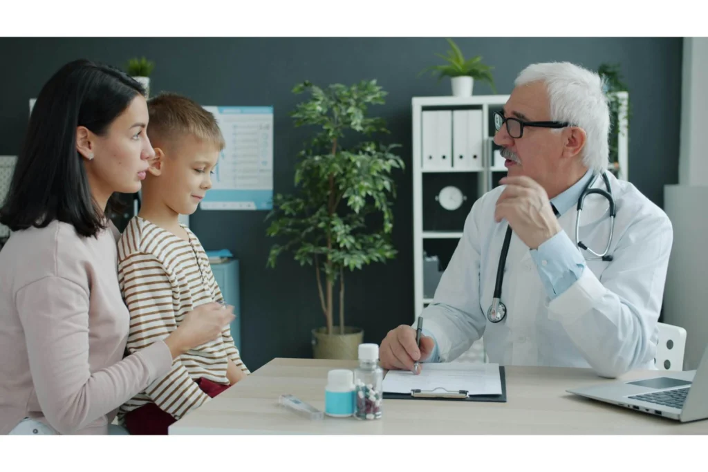 A mother and sun talking to a doctor