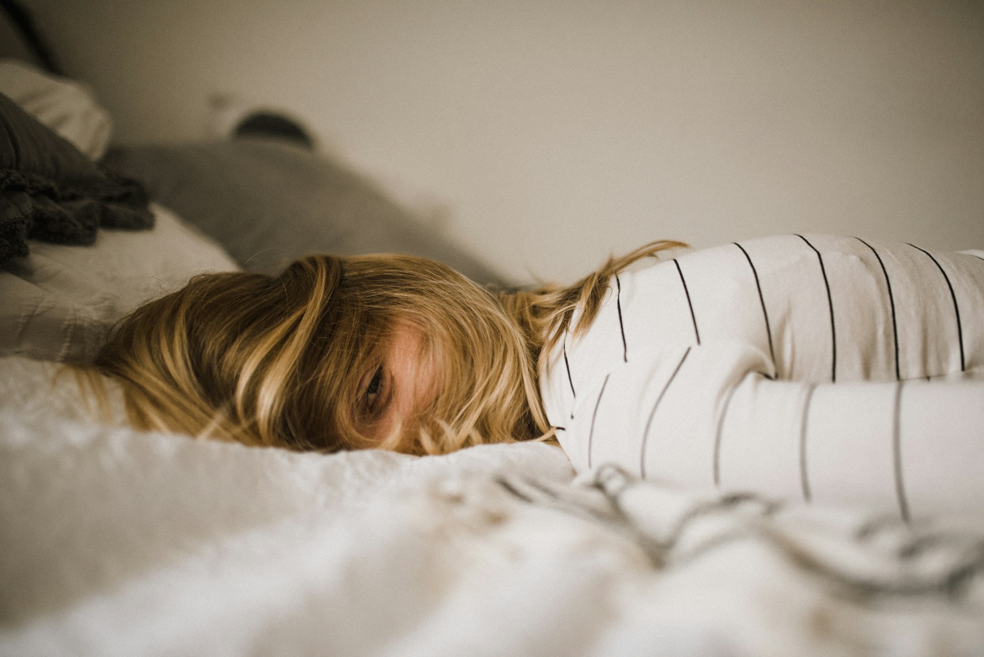 A woman sleeping on a bed