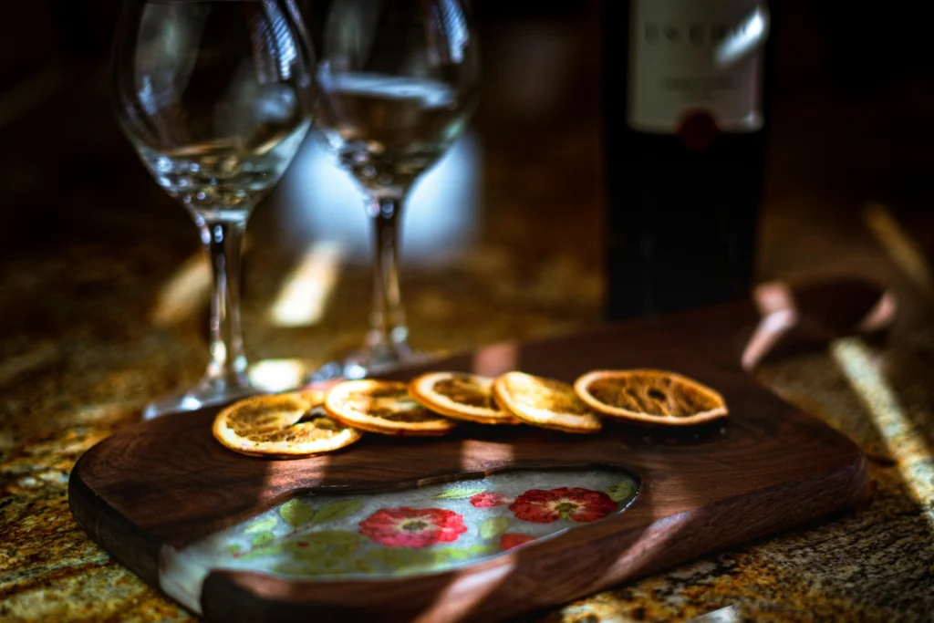 Wooden board with wine glass, styled for a moody food photography shot