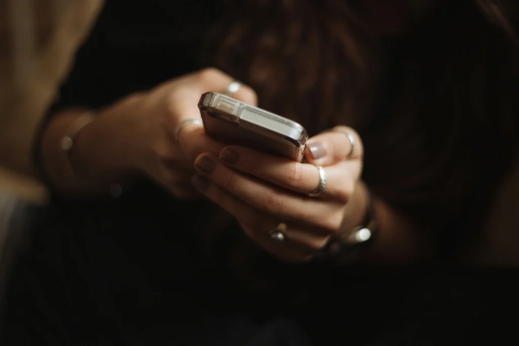 A person's hands holding a smart phone