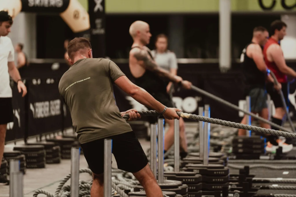 Hyrox workouts like the sled pull challenge your core and upper body strength.