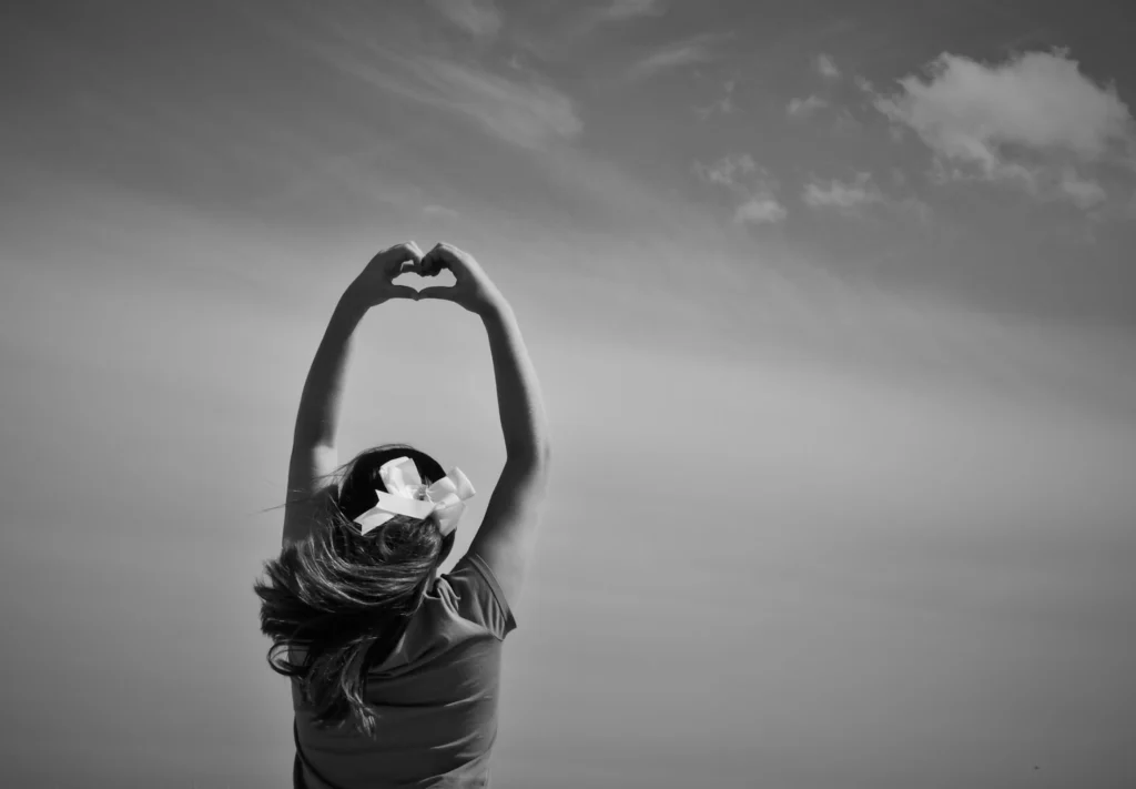 woman forming a heart shape