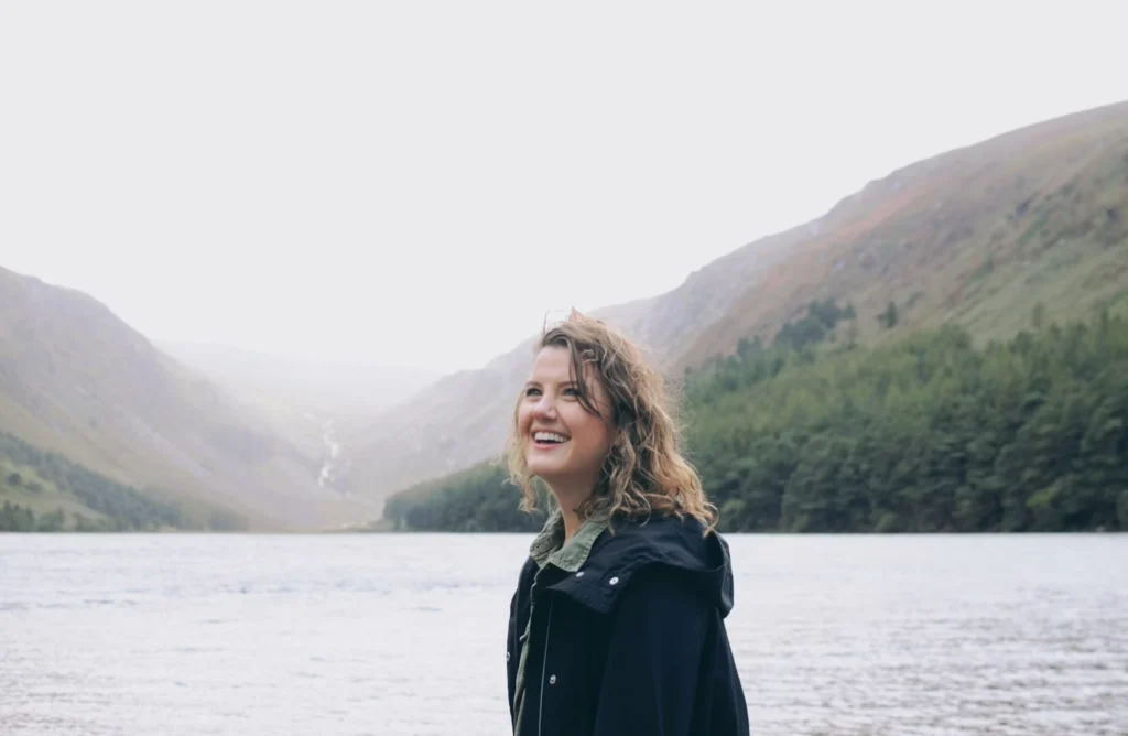 woman smiling with lake in the background