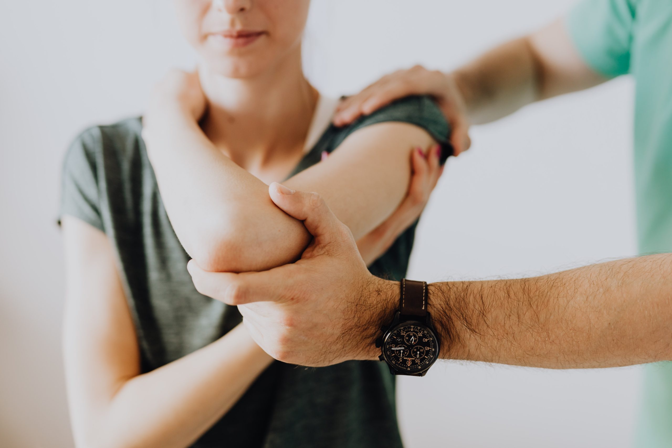 doctor helping a woman stretch her arm