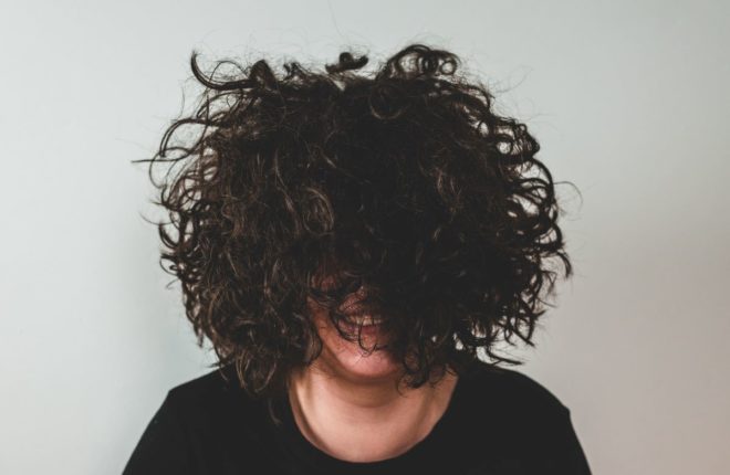 a girl with messy hair that needs to learn how to sleep with short curly hair