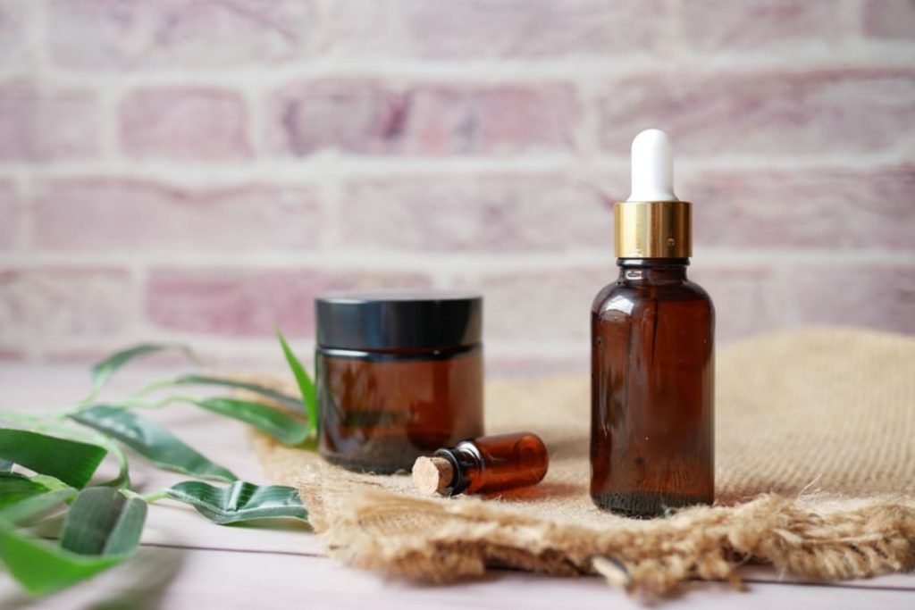 A bottle of essential oil for curly hair