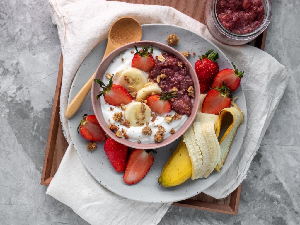 a yogurt bowl with a side of banana two great gut healthy foods