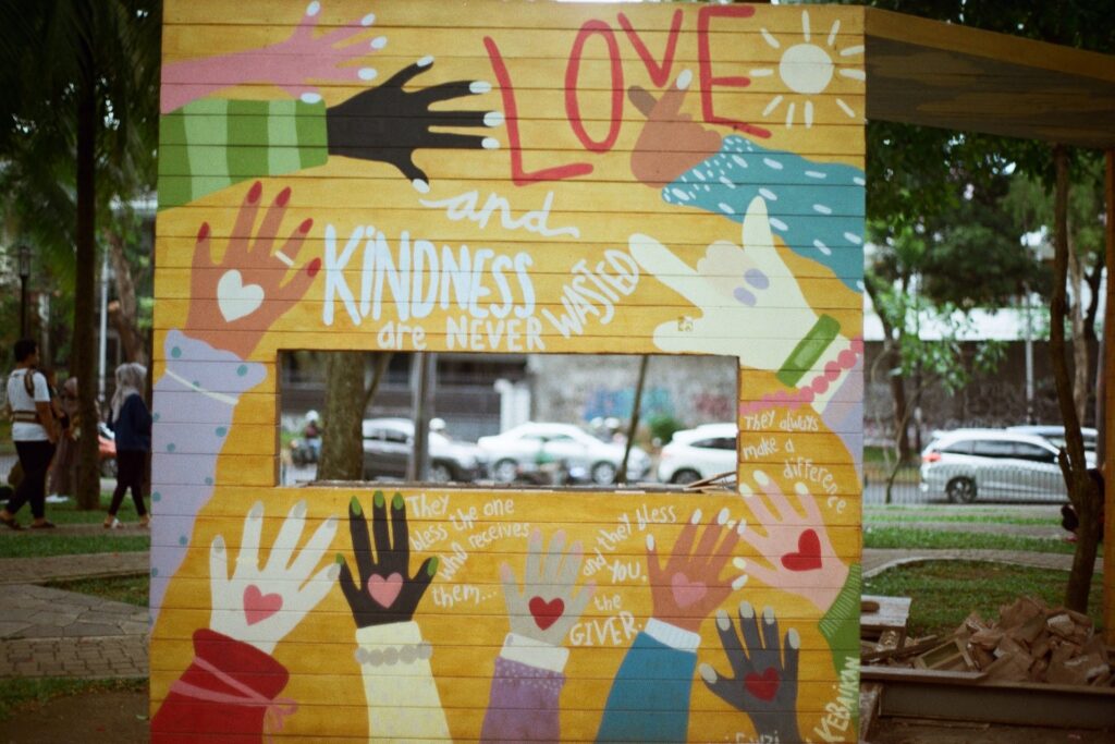 Painted Sign About Love and Kindness - difference between empathy and compassion
