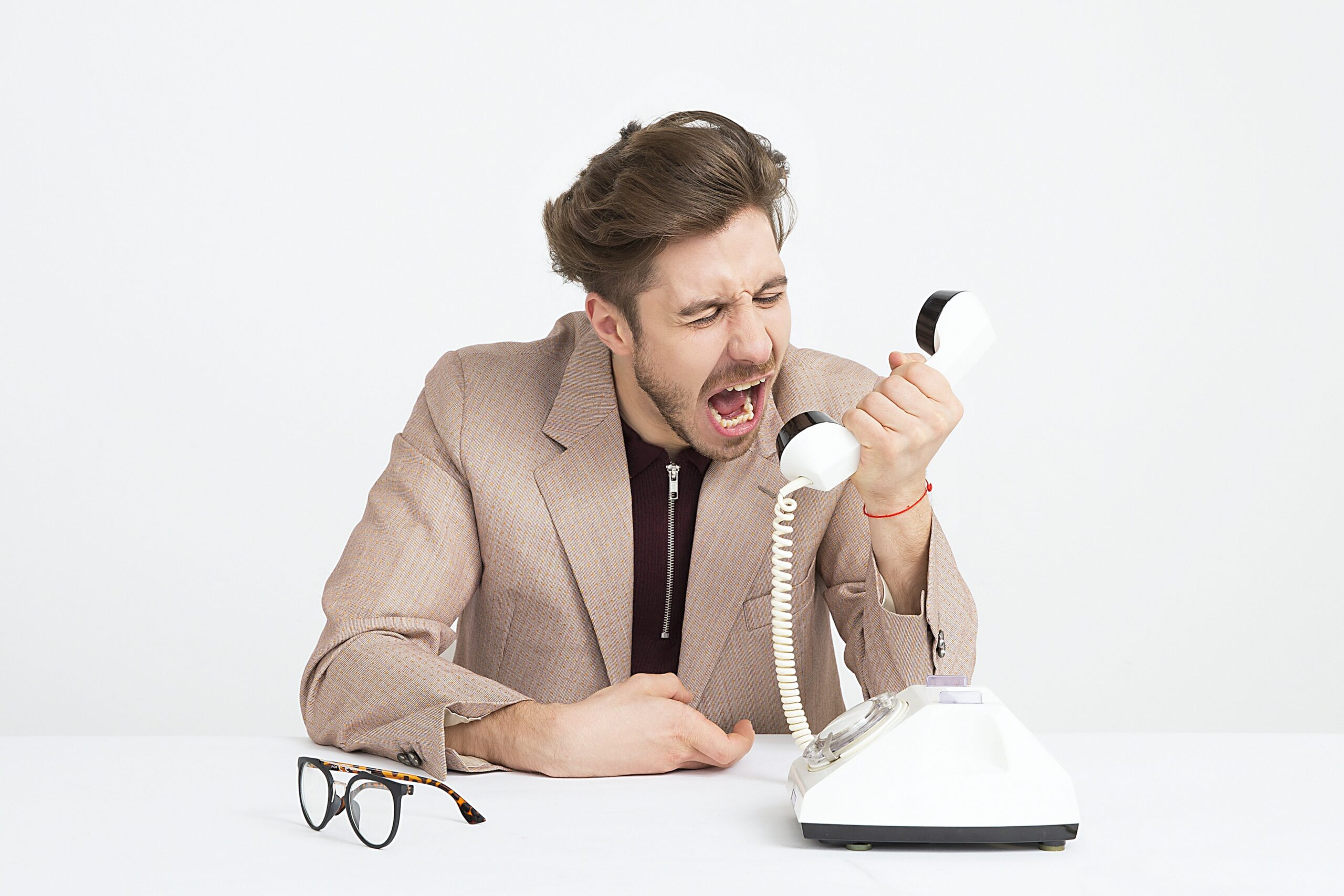 an angry man shouting at phone