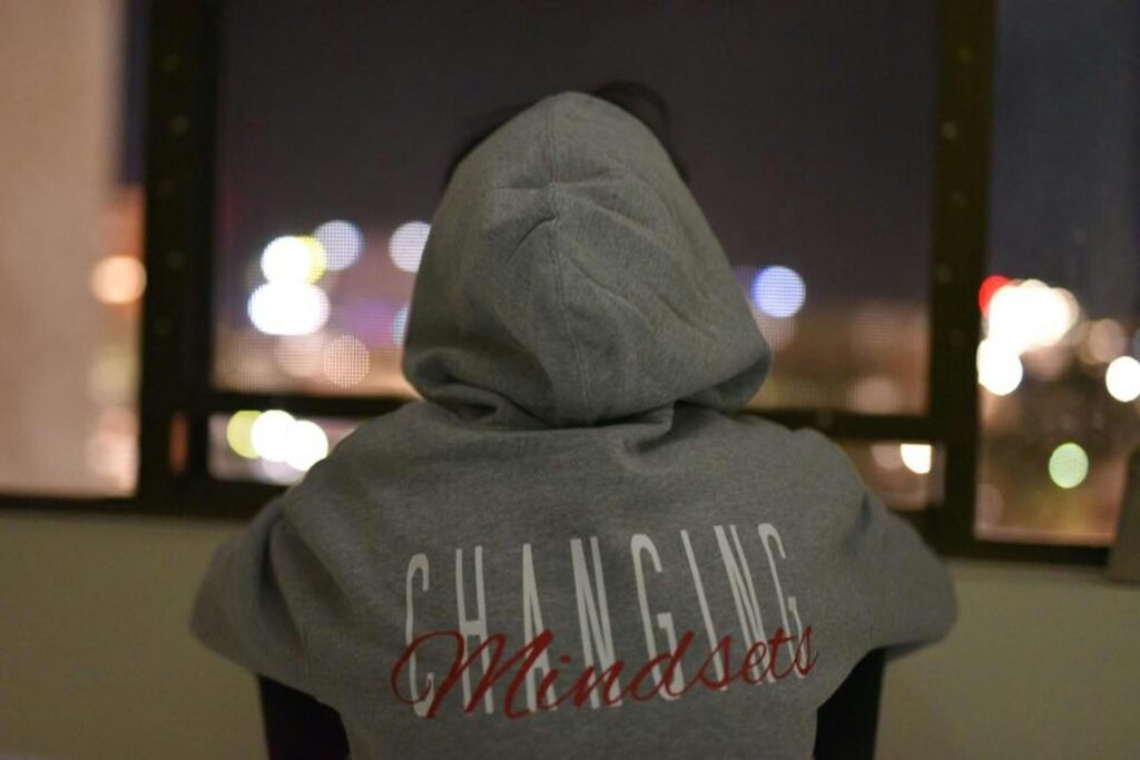 A person wearing a hoodie with words Changing Mindsets - what is a fixed mindset