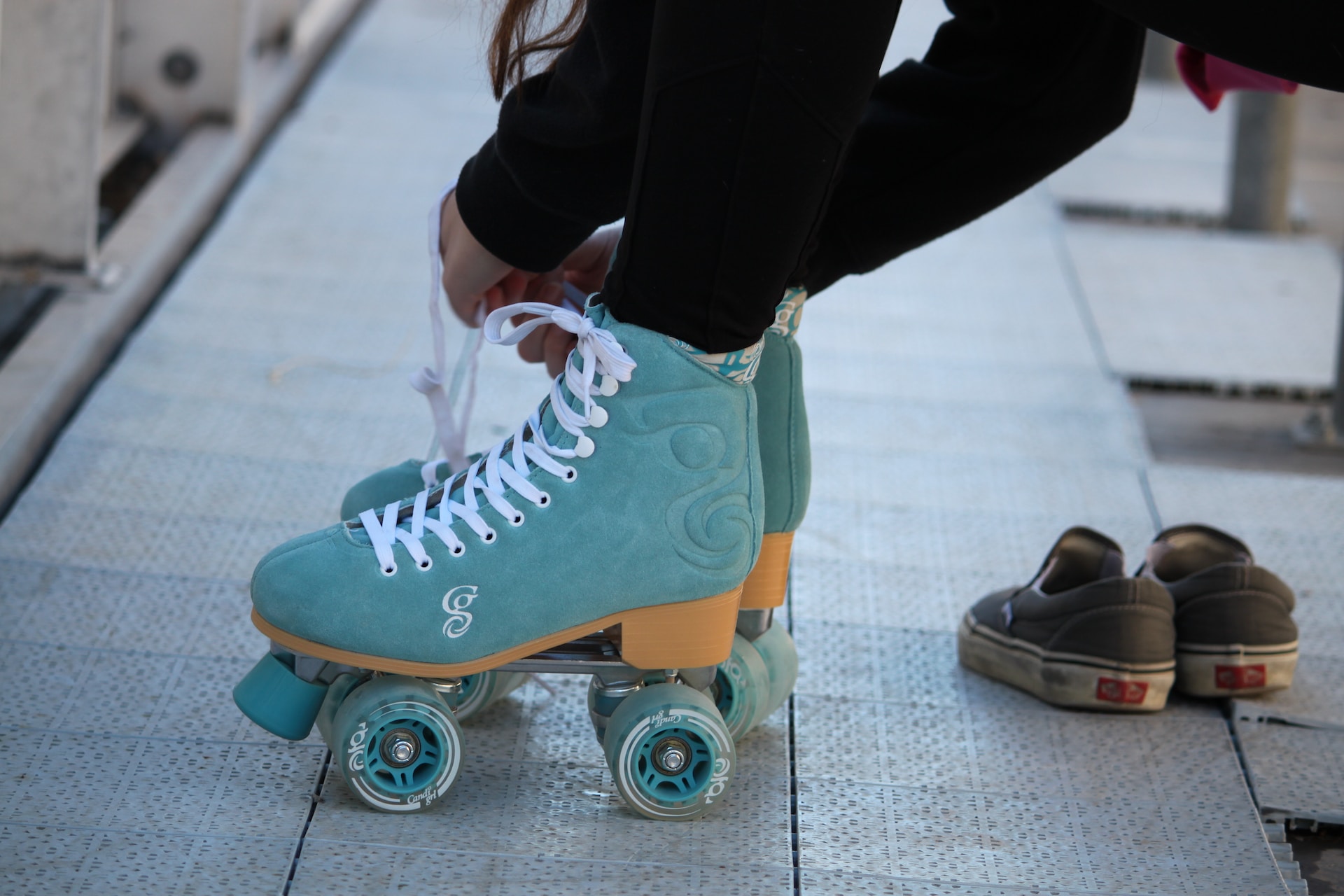 A person putting on skates before going rollerblading.