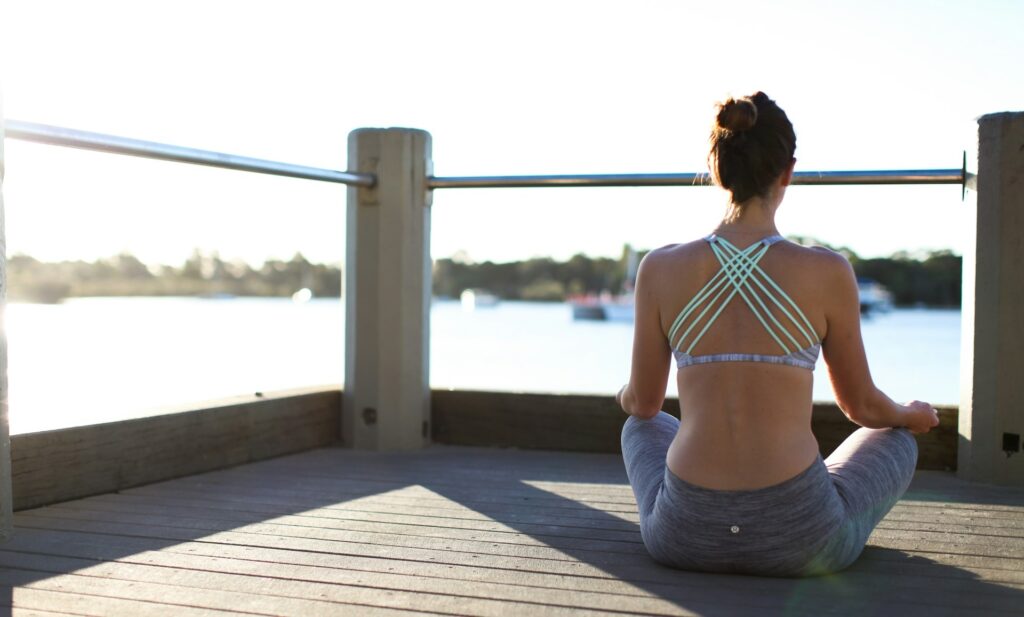 Woman Meditating on a Dock
