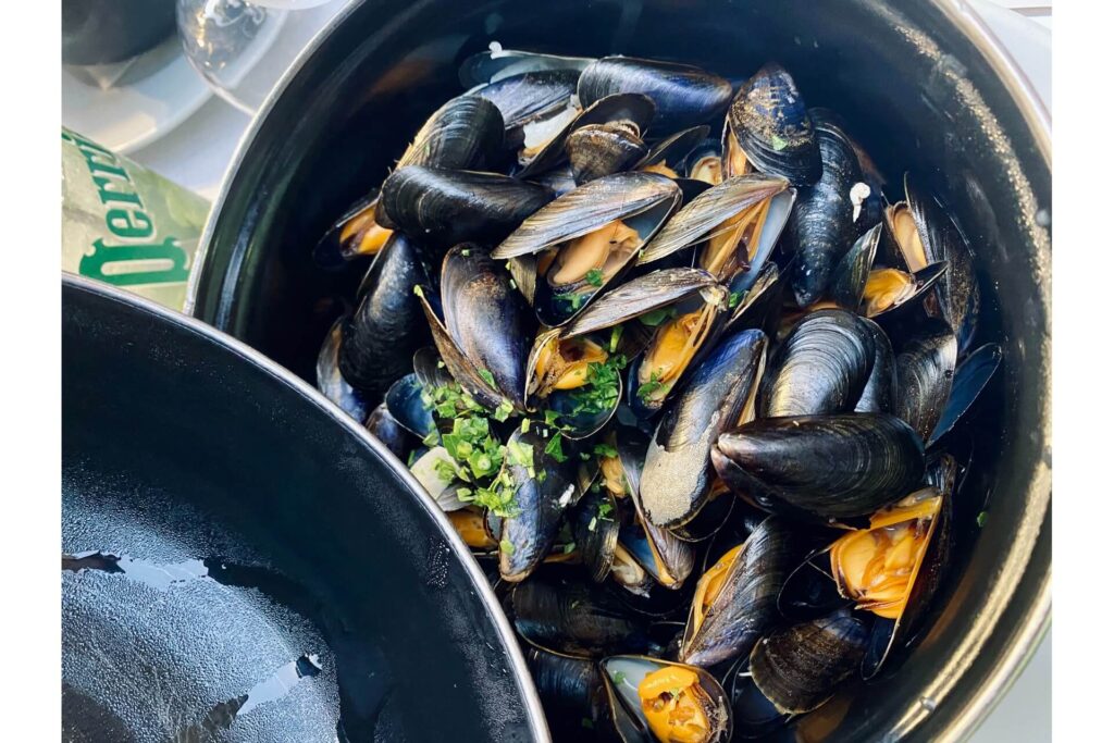 A pot of cooked mussels.