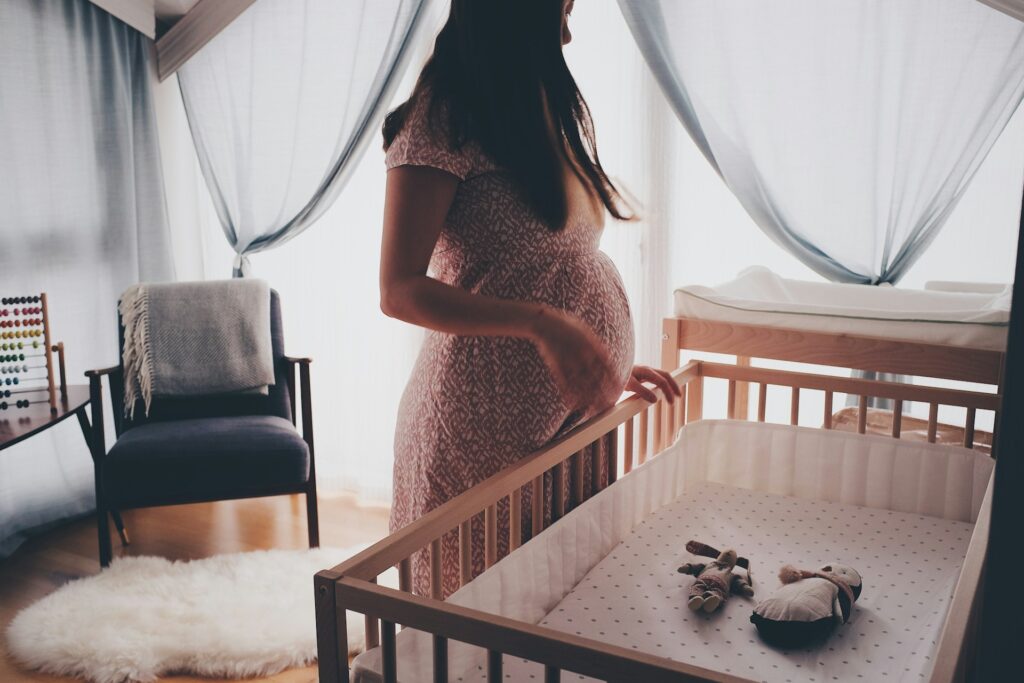 Pregnant Woman Standing in a Nursery