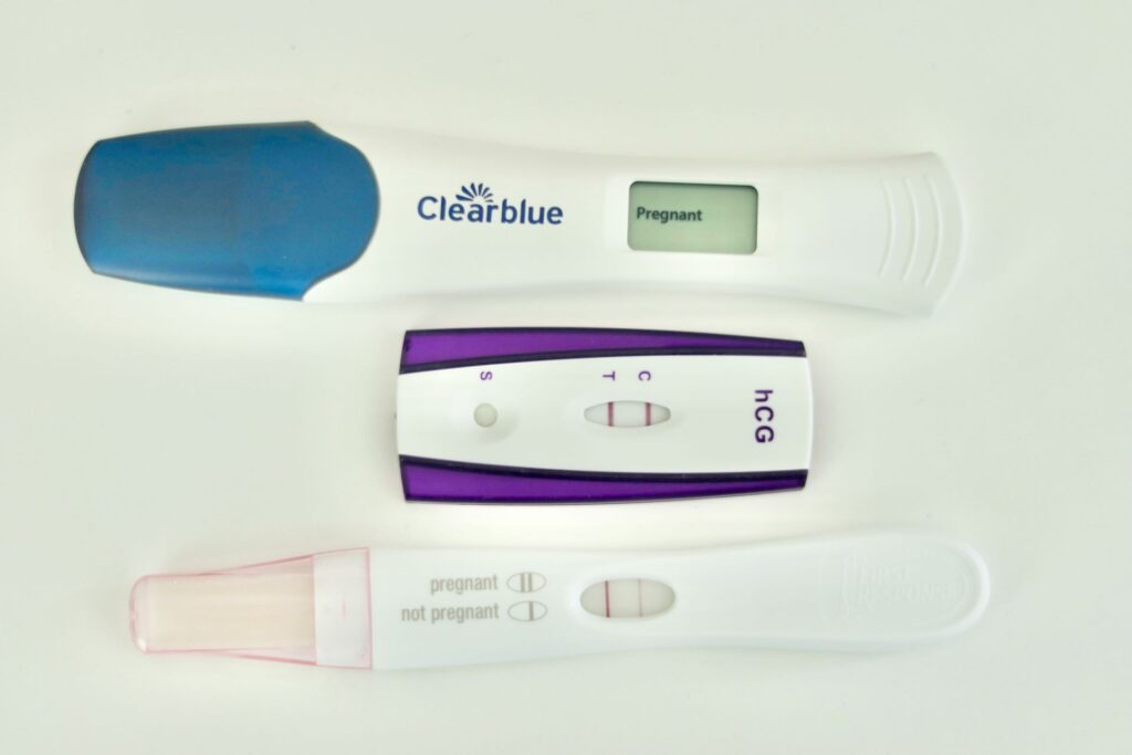 Three positive pregnancy tests in a column. 