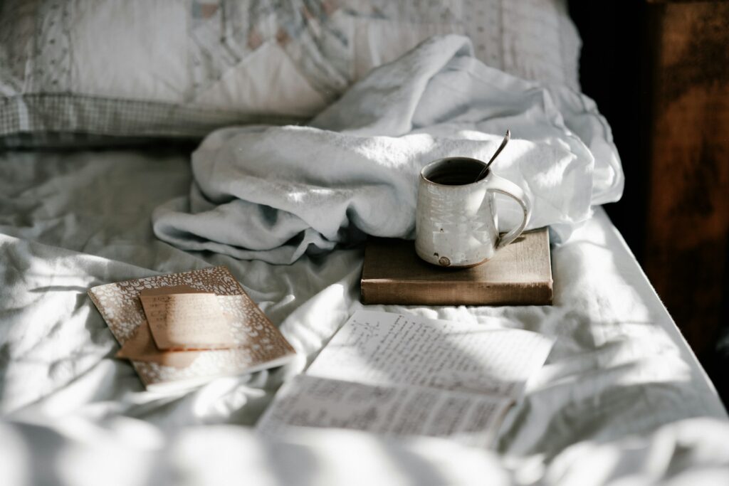 Journal on White and Gray Bed Sheet