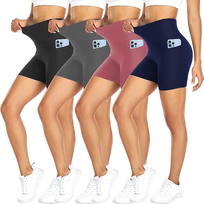 Four women stand on their toes while wearing the same legging biker shorts in four different colors. They each hold the waistbands out to reveal the fabric's stretch and all have one phone in their pockets.
