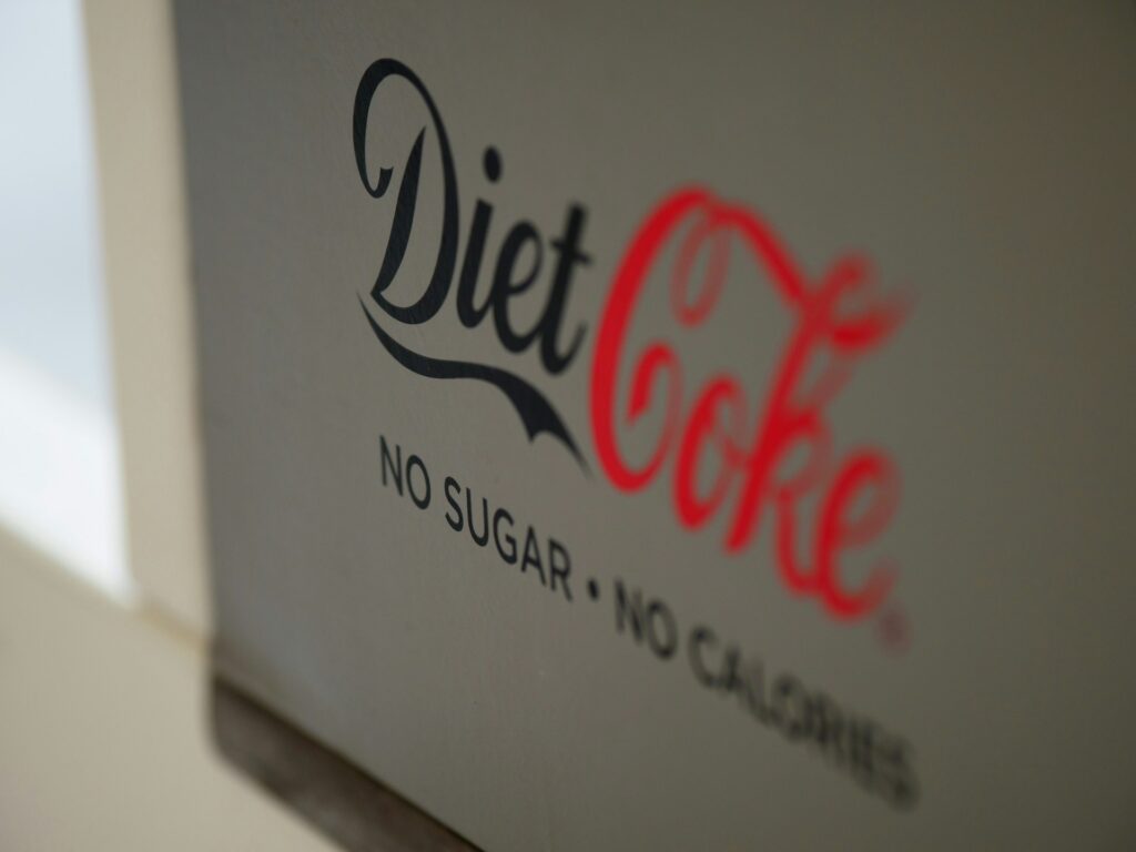 A Diet Coke sign that says no sugar and no calories below the brand.