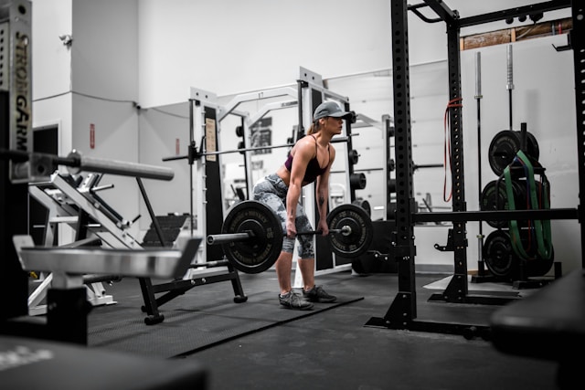 A woman lifting weights at the gym